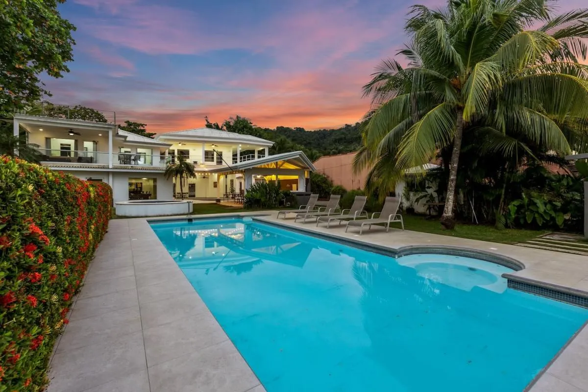 View of the pool and front facade of Casa Blanca beachfront vacation rental in Jaco, Costa Rica